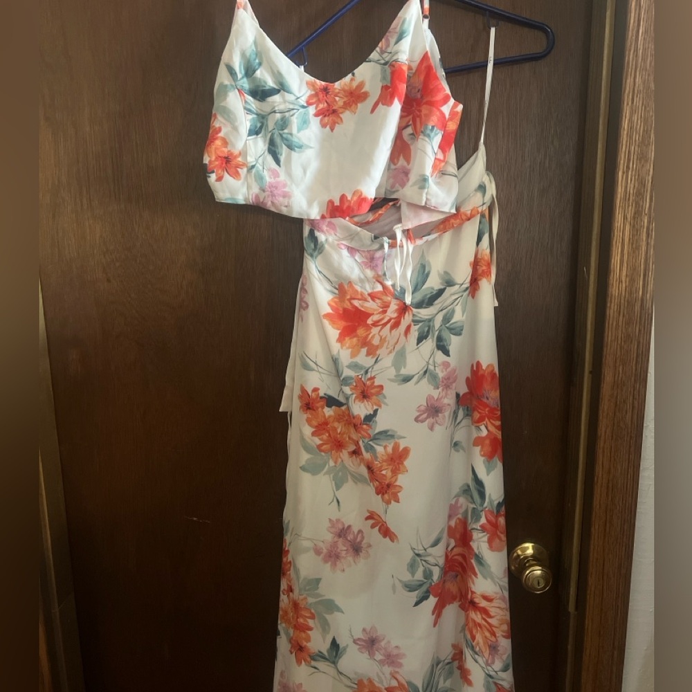 Two-piece top and floor length wrap skirt set. White with pink floral pattern.